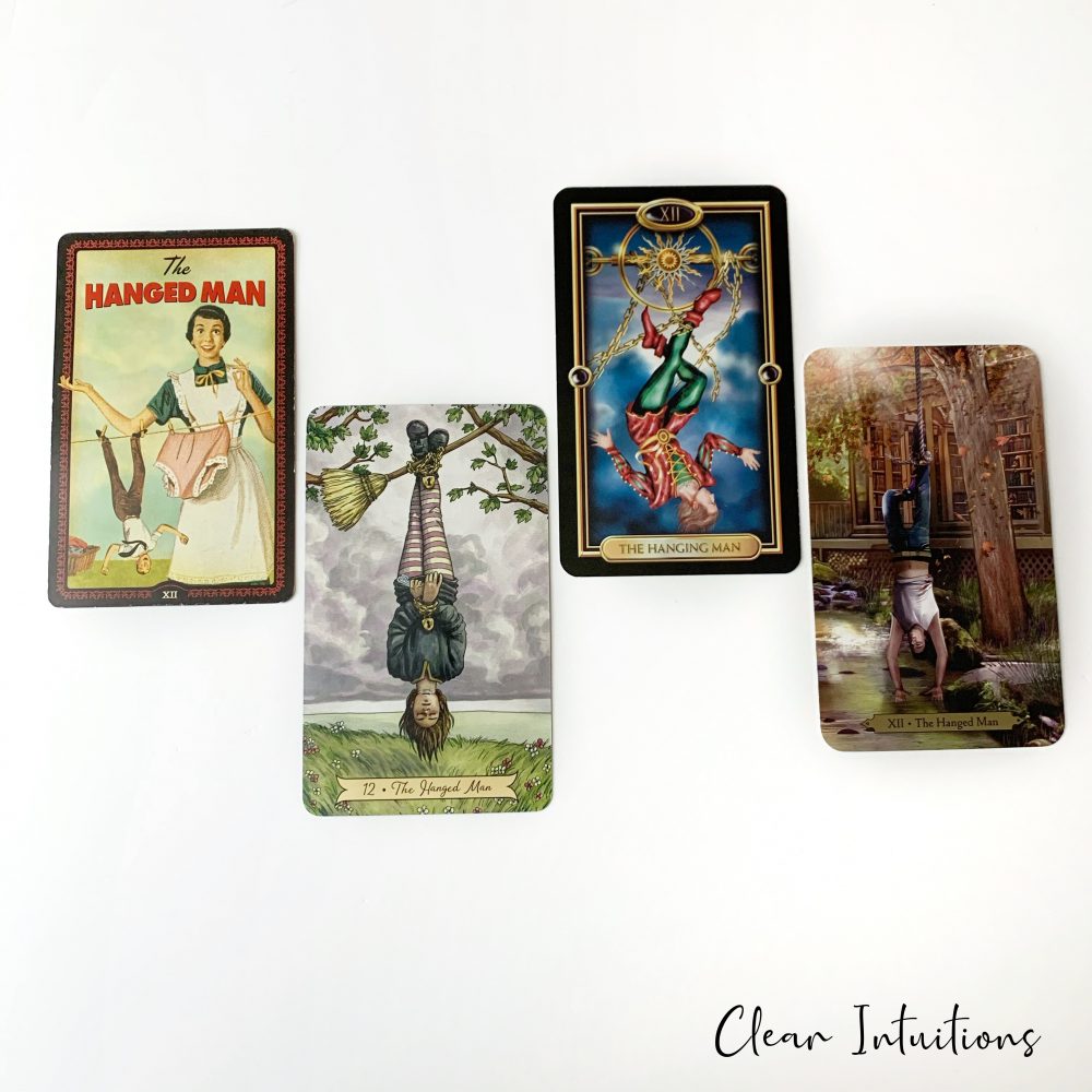 Tarot by Comparison™ - The Hanged Man Tarot Card Meaning 3 The Hanged Man Tarot Card - The Housewives Tarot, Wizards Tarot, Gilded Tarot, Crystal Visions Tarot